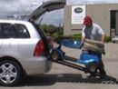 image a a scooter being ramped into a car